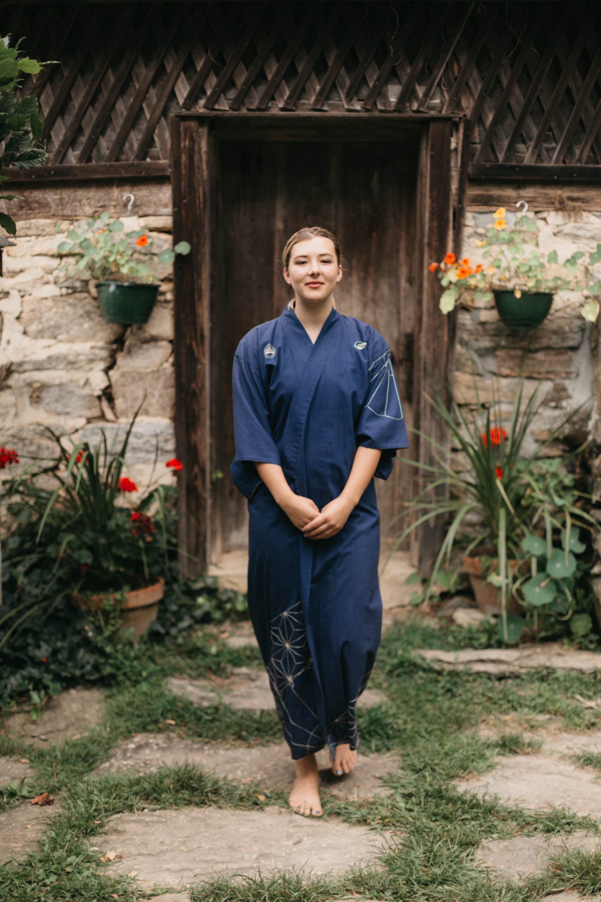 Woman walking outdoors in Kimono walking towards camera.