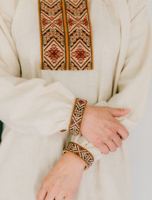 Close up photo of embroidery on neck opening and cuffs of View B.