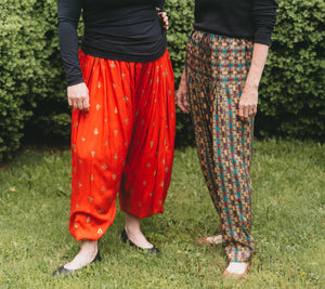 Two women standing side by. Photo from waist down.  Woman on left is wearing 119 Sarouelles (View A Turkish Pants).  Woman on right is wearing view C (Indian pants).