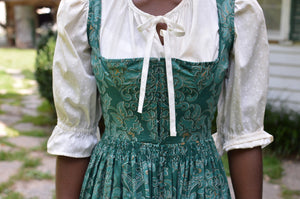 Close up photo of the bodice  and waist gatherings of View B Dirndl.  Model is wearing View A blouse with tie closure at neckline.