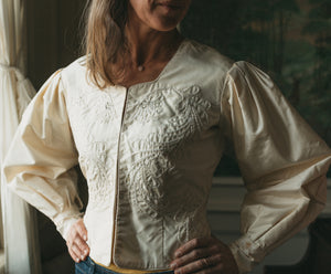 Close up photo of woman wearing modern version View B.  Jacket front is embellished with bead work on both  front panels