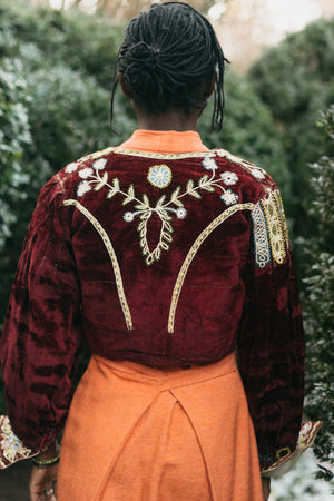 Back view of 124.  This is an original garment made in traditional velvet with beading and braid trim