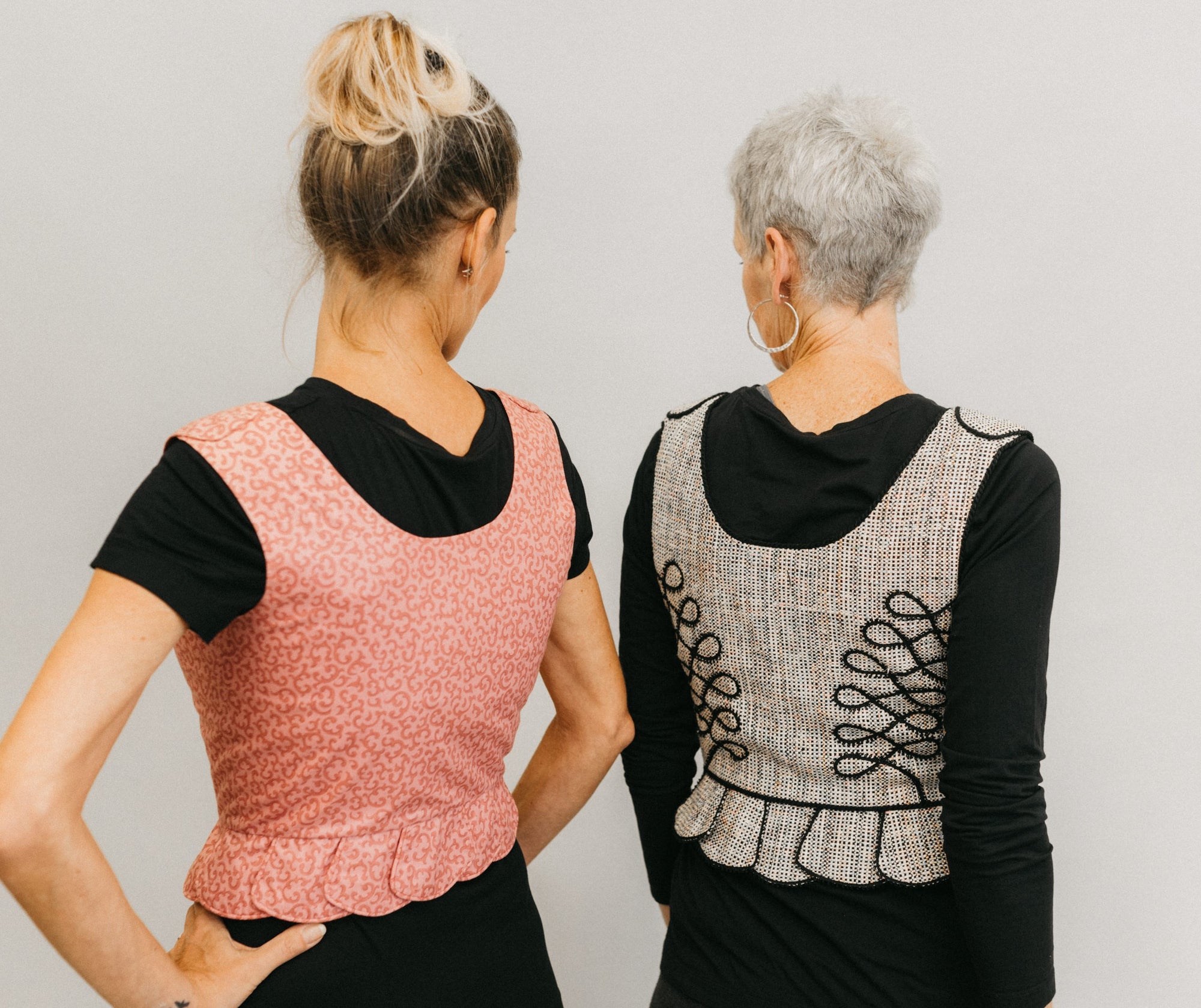 Photo of two women in Polish Vests.  Vest on right shows embellishments.