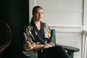 Young woman sitting outdoors wearing floral haori jacket