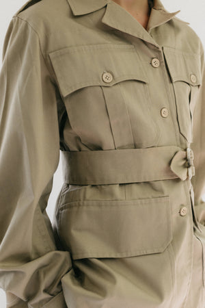 Close up photo of Jacket front/side view.  Shows pocket, collar, buttons, and belt details.