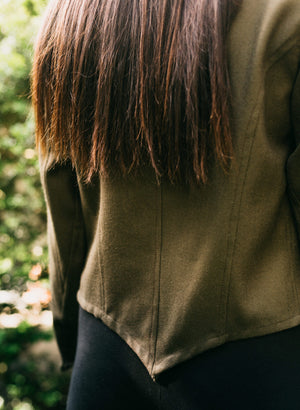 Close up of back of Woman wearing a brown Belgian Military Chef's Coats.