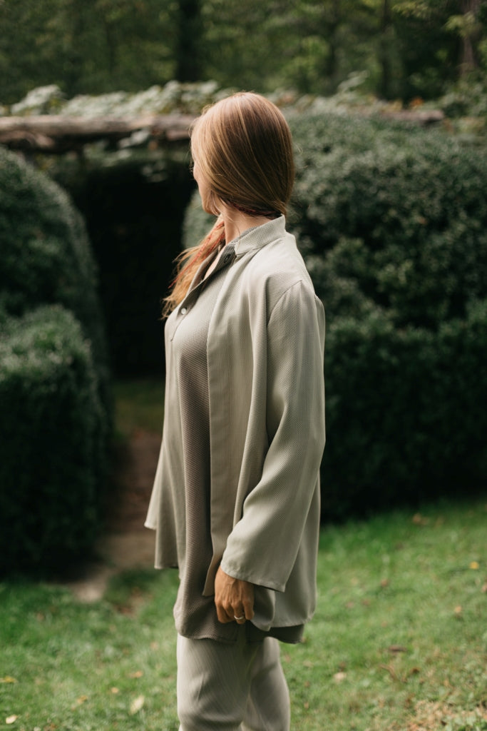 Side view of model wearing kurta, churidar and adapted Kurta jacket.