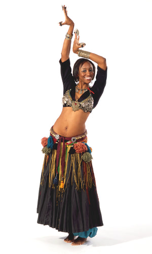 Photo of woman in tribal style belly dance outfit.  She poses with her arms raised in a dance pose with ornate coin bra and layered tassel belt.