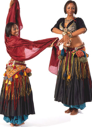 Photo of front and back views of woman in full tribal belly dance outfit.  In back view woman is holding a scarf in arms and looks back over her shoulder towards the camera.  The front view shows her standing with arms crossed in front of her holding cymbals.