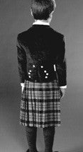 Black and white photo of back view of Prince Charlie Jacket and Kilt on young boy.