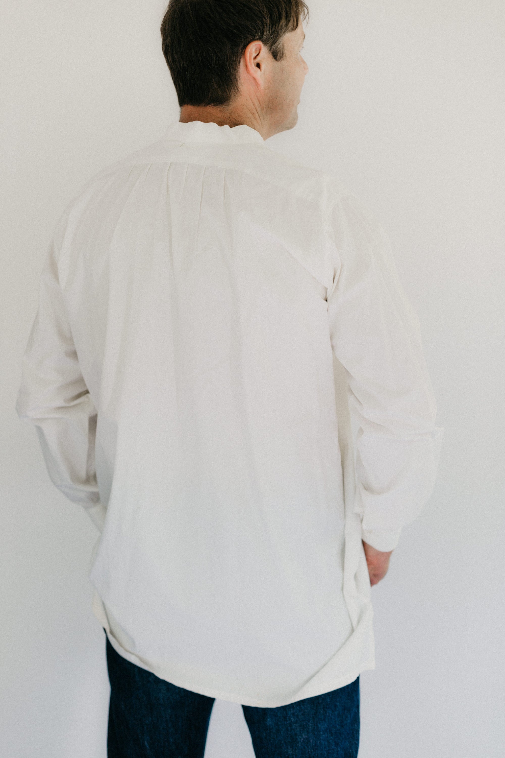 Photo of man standing with victorian shirt back view 