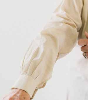 Close up photo of sleeve pleats and cuff.