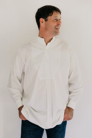 Photo of man standing wearing Victorian Shirt in front of studio backdrop. 