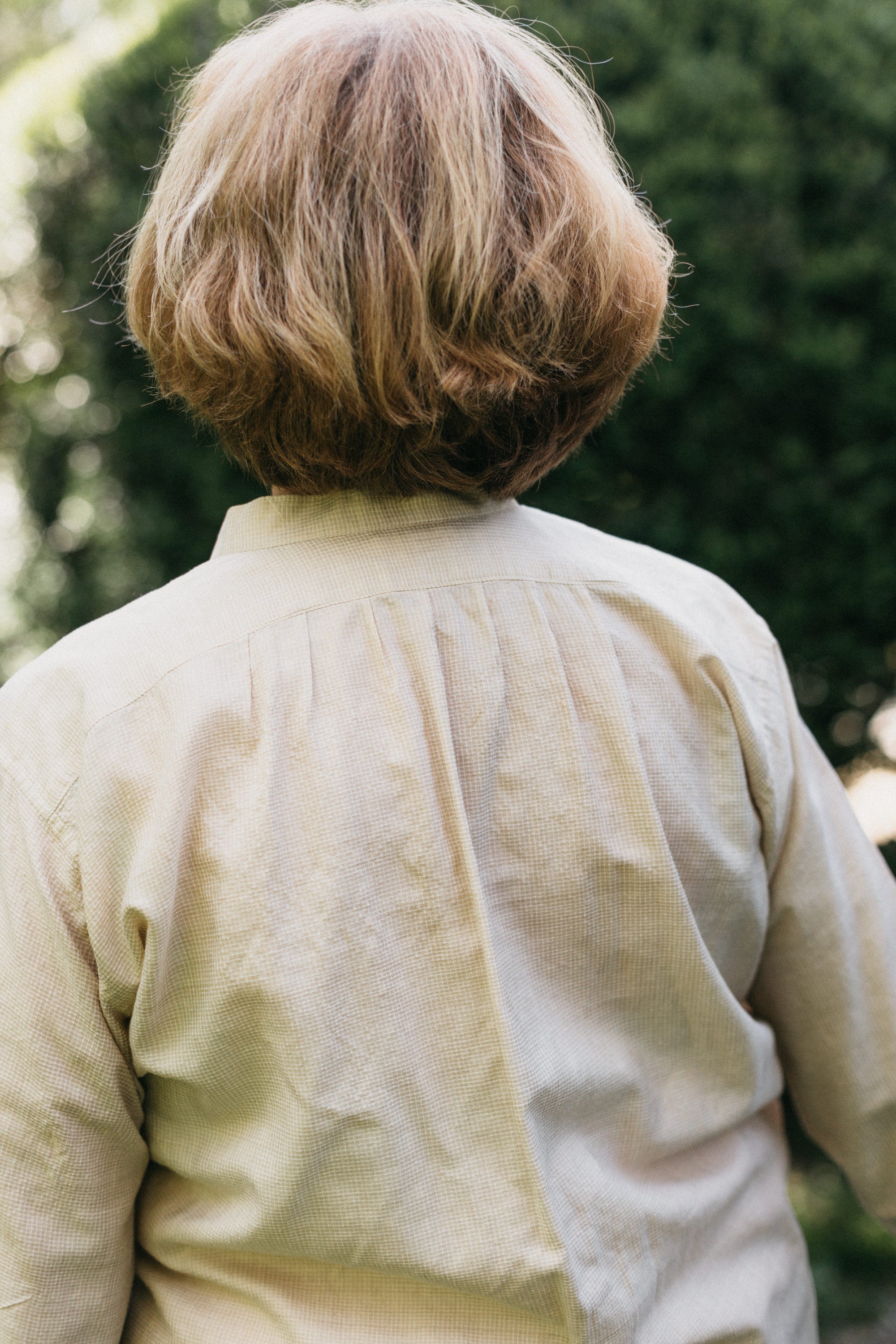 Close up back view of woman wearing Victorian shirt.  Photo shows pleats at upper back.