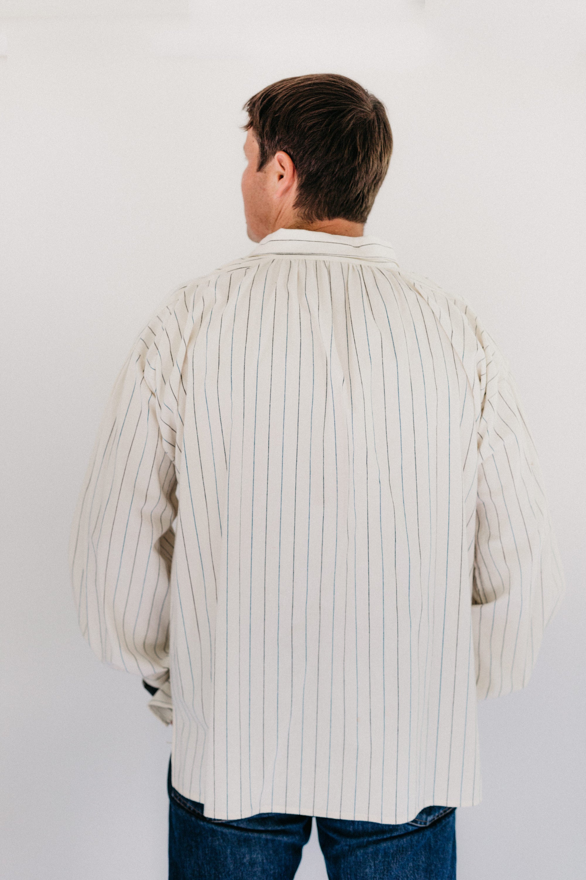 Man standing in front of a white studio backdrop wearing 204 Missouri River Boatman's Shirt.