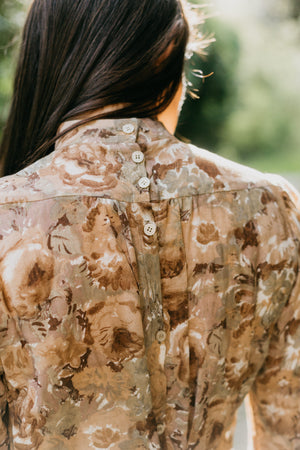 close up back view of brunette woman wearing 205 Gibson Girl Blouse, back fastened with tiny buttons. 