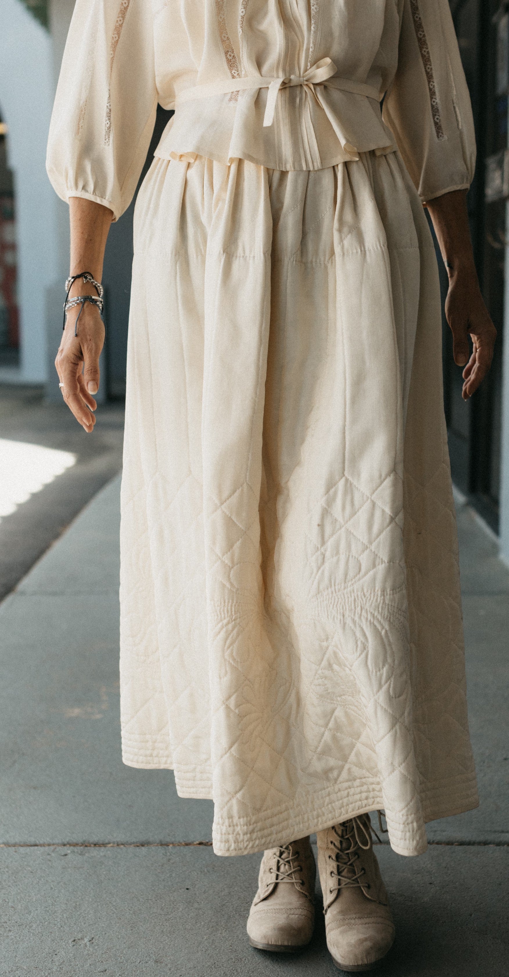 Close up waist down view of woman wearing 206 Quilted Prairie Skirt showing quilted details.