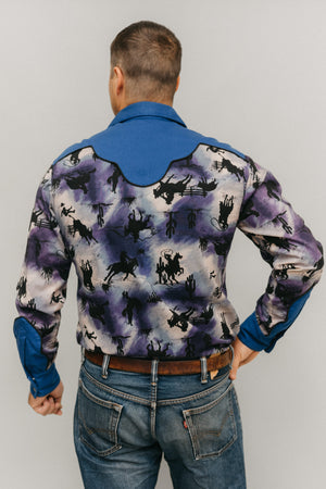 Back view of man standing in front of a white studio backdrop wearing 212 Five Frontier Shirt with decorative yoke in the back.