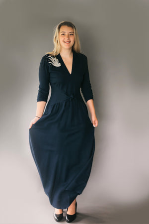 young blonde woman standing in front of a grey studio backdrop wearing 233 Glamour Girl Dress.