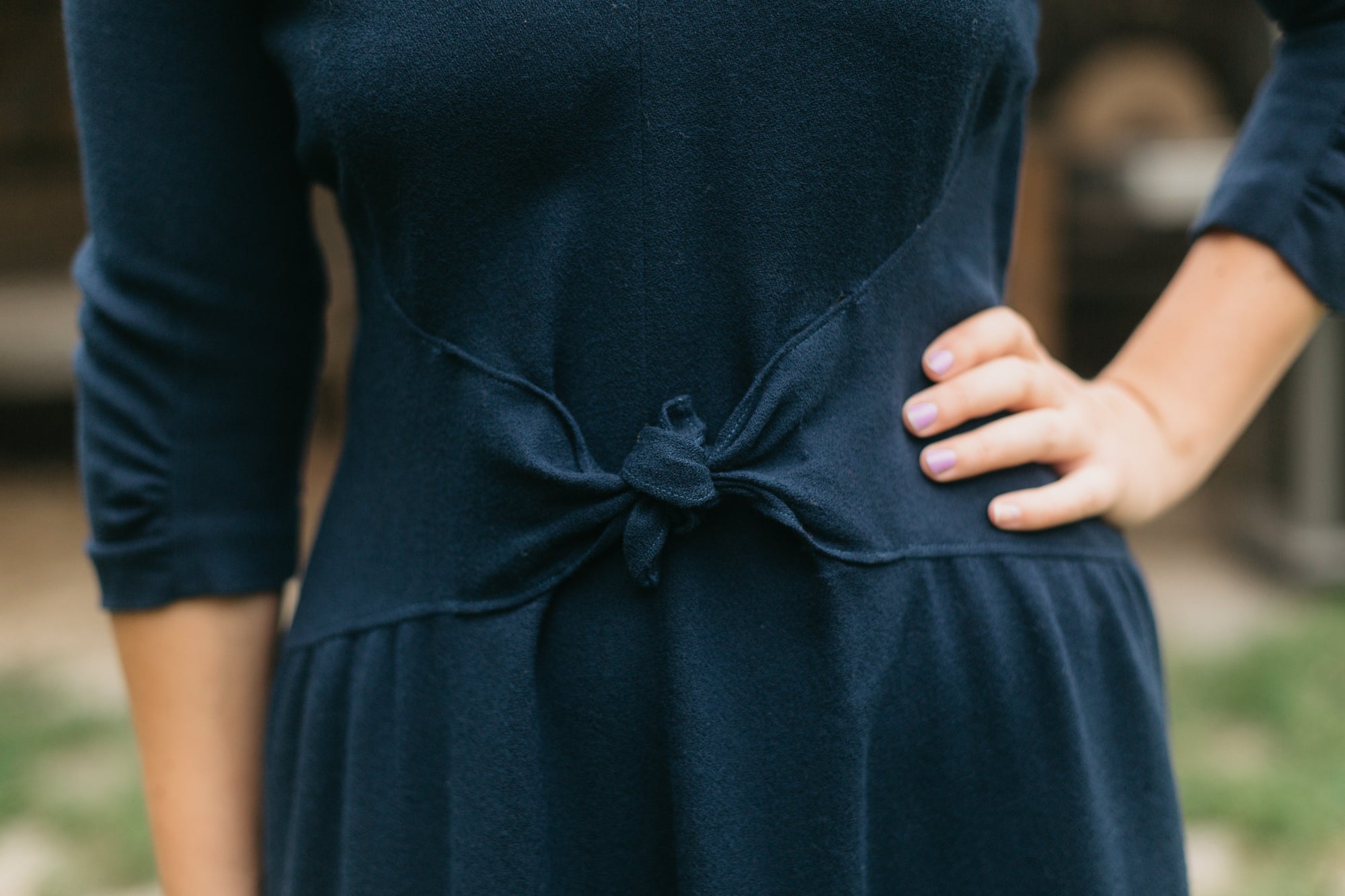 Close up of the front bodice and skirt gathered into a curved midriff that tied at center front, created a snug individual fit.