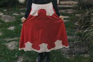 Close up of 243 Rodeo Cowgirl Skirt fanned out with hands surrounded by greenery