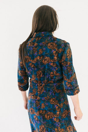 Back view of woman standing in front of a white studio backdrop wearing 247 Lindy Shirtdress