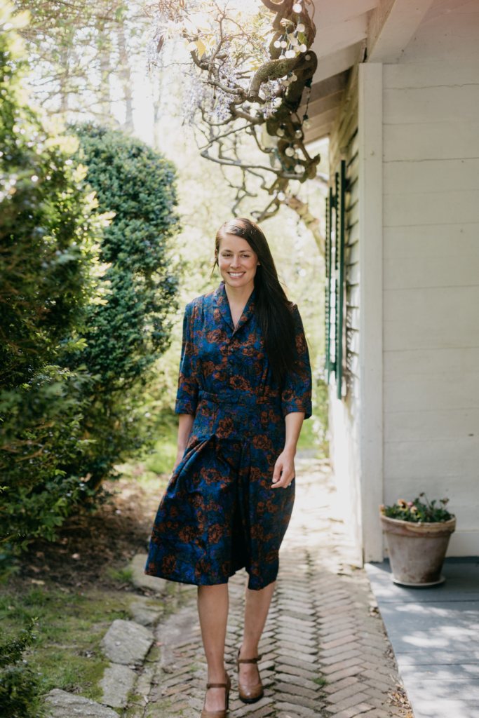 Woman walking surrounded by greenery wearing the 247 Lindy Shirtdress