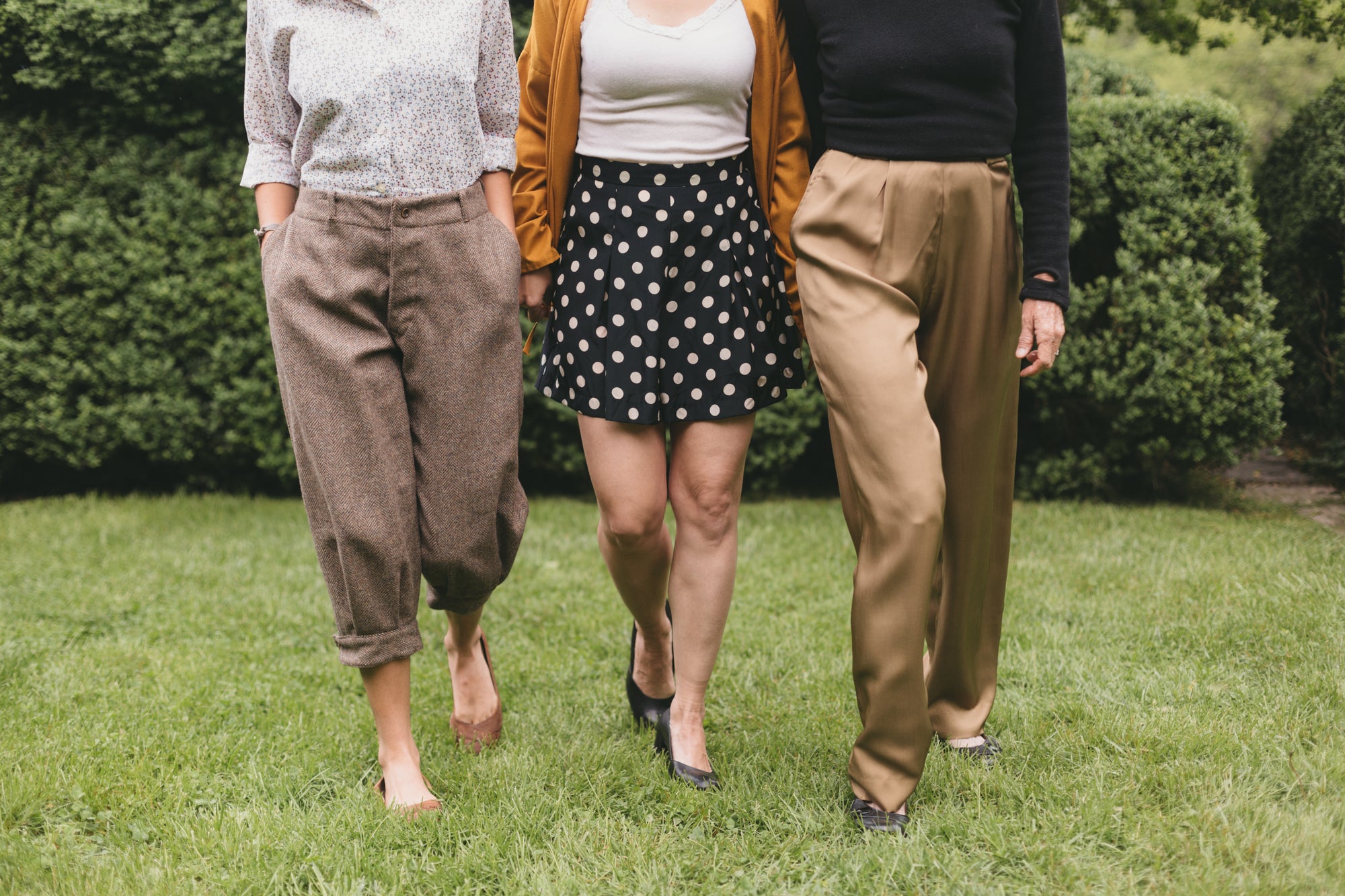 three women walking surrounded by greenery one wearing the trousers, shorts and pants from 250 Hollywood Pants