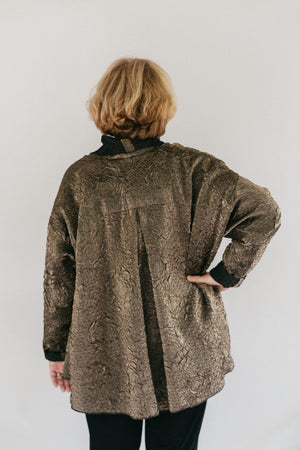 Back view of woman wearing the hip length 254 Swing Coat with hand in her hip.