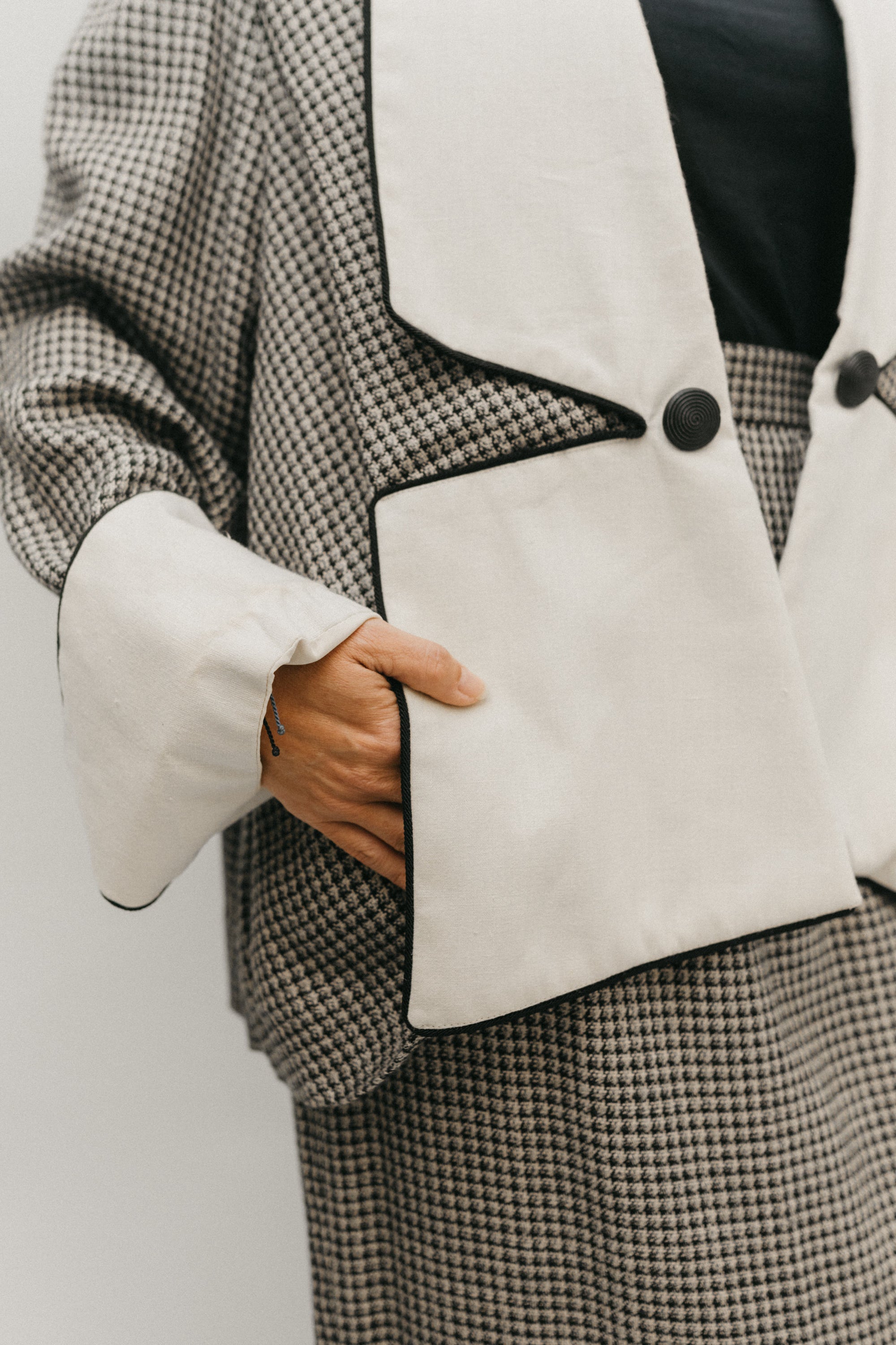 Close up #255 Swing Suit of woman with hands in the pocket the wide lapels that are stitched down to form pockets for the Trapeze Jacket.