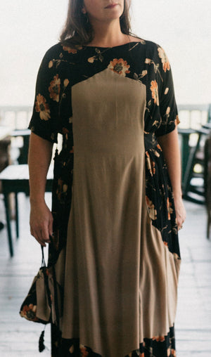 White woman wearing the Promenade Dress showing the attached bib shaped overdress.