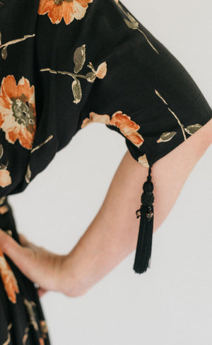 Close up of the sleeve of the Promenade Dress with the decorative cord hanging from the sleeve.