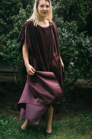 Young blonde White woman surrounded by greenery, wearing the Monte Carlo Dress with V-Neck Tunic on top.