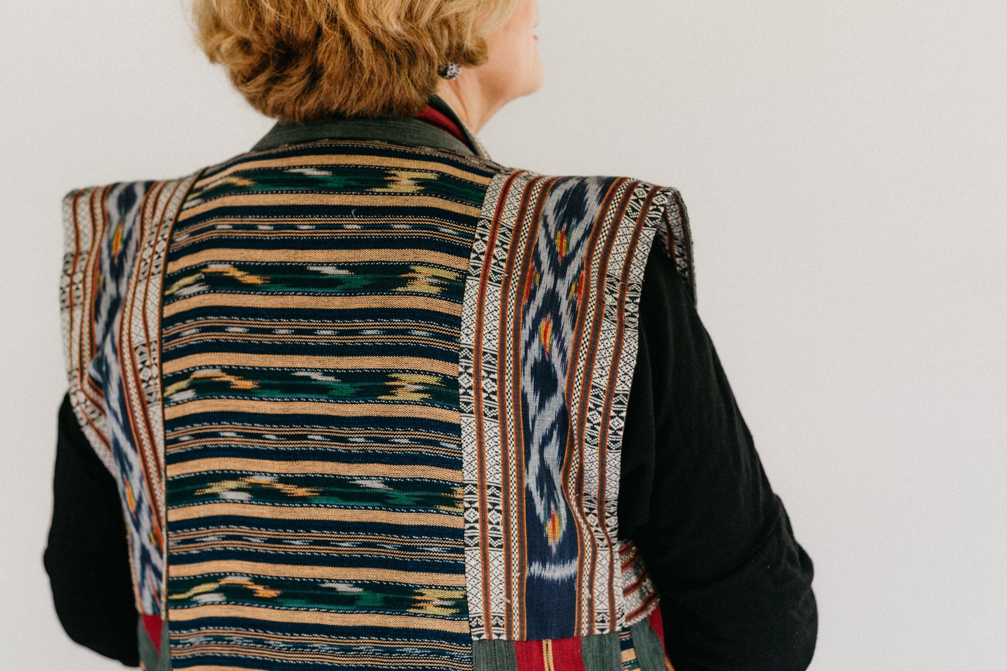 Close up photo of upper back of panel coat.  Coat is made in woven ikat fabric.