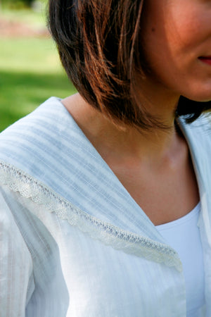 Close up of the collar of the Metro Middy Blouse in white with a lace trim.