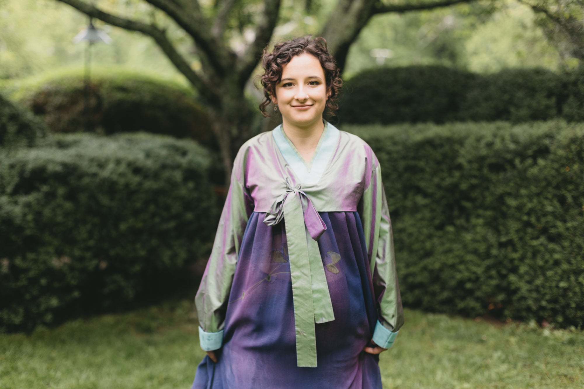 Young woman walking in han bok.  Photo of upper dress and jacket. Photo shows front v-neck  and tie as closure for the jacket.