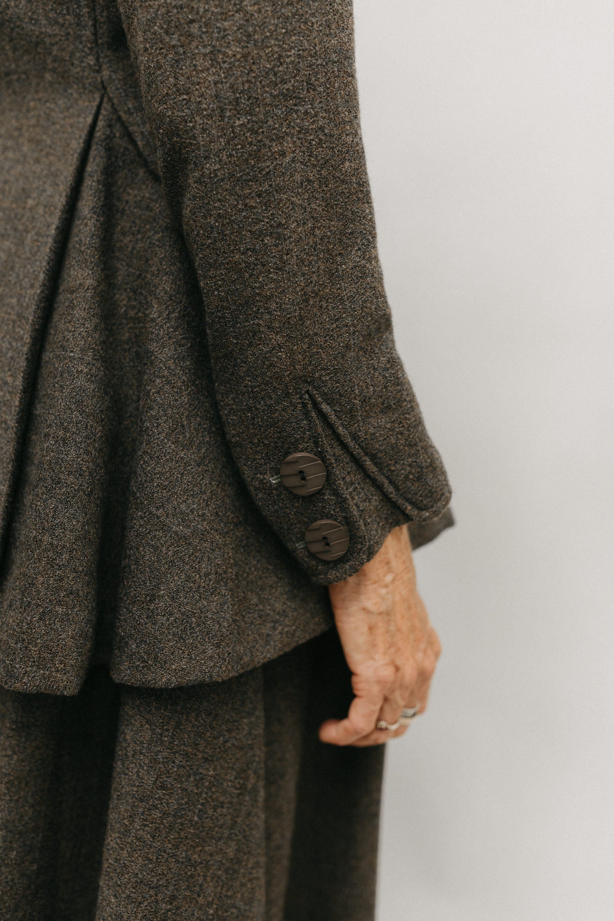 Close up of decorative button insets adorn of the cuff of the traveling jacket 