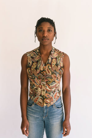 African woman standing in front of a white studio backdrop, wearing View A 222 Vintage Vests, collarless v-neck.