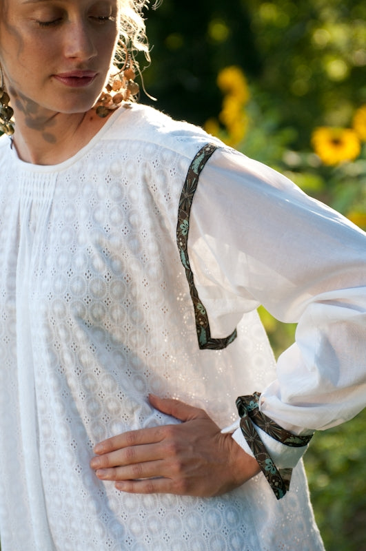 Close up of the sleeves connected to the side panels with gussets that are pleated at the wrists.