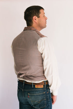 Back side view of man standing in front of a white studio backdrop, wearing View B with a back waist belt that adjusts the fit.