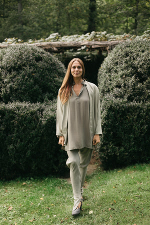 Model walking outdoors wearing Kurta and churidar with an adapted jacket made using the kurta pattern.