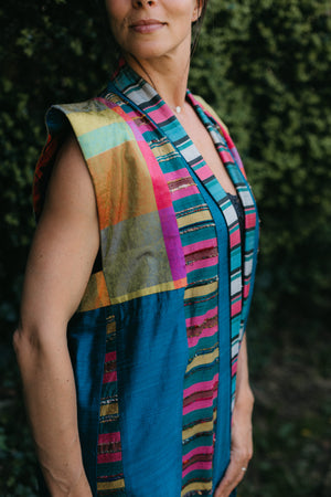 Woman wearing multi colored 118 Tibetan Panel coat. Close up of shoulder and front neckline.