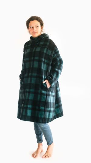 Photo of young woman wearing parka.  Model is slightly turned to show pocket set into front panel seam.
