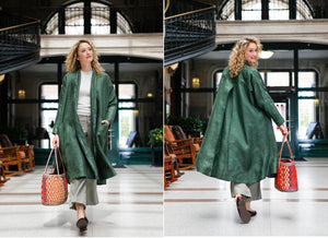 Front and back view of white blonde woman walking holding a woven bag wearing the 254 Swing Coat