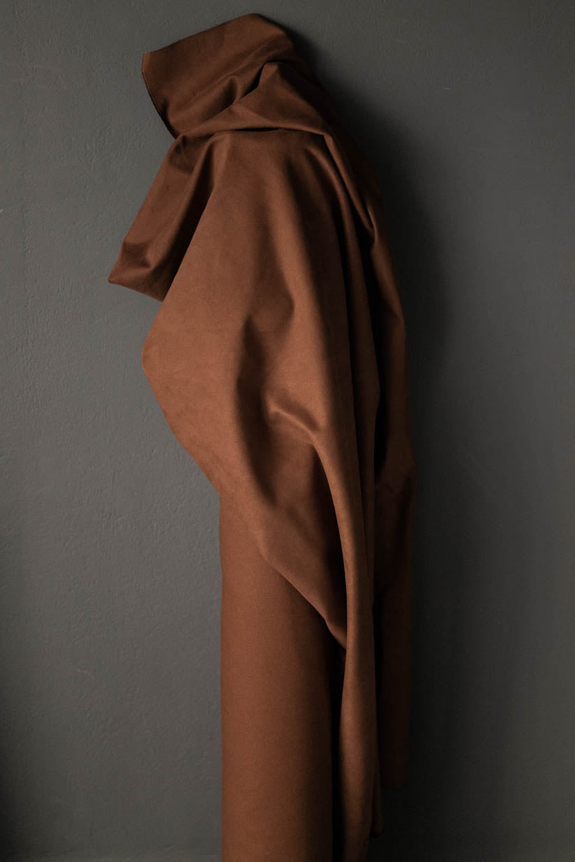 A bolt of tobacco brown cotton sanded twill fabric.